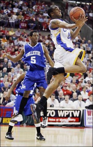 Libbey's William Buford glides in for a spectacular reverse
layup. He scored 29 points with six rebounds and five assists.