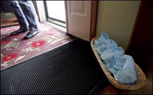 The Dillions keep shoe covers by the door to keep their home's floors clean for potential buyers.