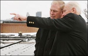 Mayor Carty Finkbeiner, right, makes a point to Gov. Ted Strickland as solar panels are installed atop the art museum.
