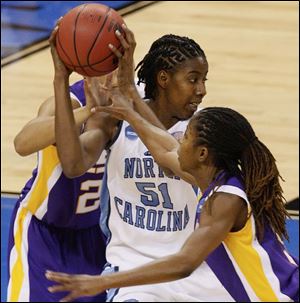 LSU's Jessica Breland keeps the ball away from North Carolina's Mesha Williams, right.