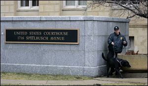 A U.S. Marshall with a dog conducts a security check around the federal courthouse in Toledo on Tuesday morning. The trial of three men on trial for for terrorism conspiracy charges started Tuesday. (THE BLADE/DAVE ZAPOTOSKY)
<br>
<img src=http://www.toledoblade.com/graphics/icons/photo.gif> <b><font color=red>VIEW</b></font color=red>: <a href=