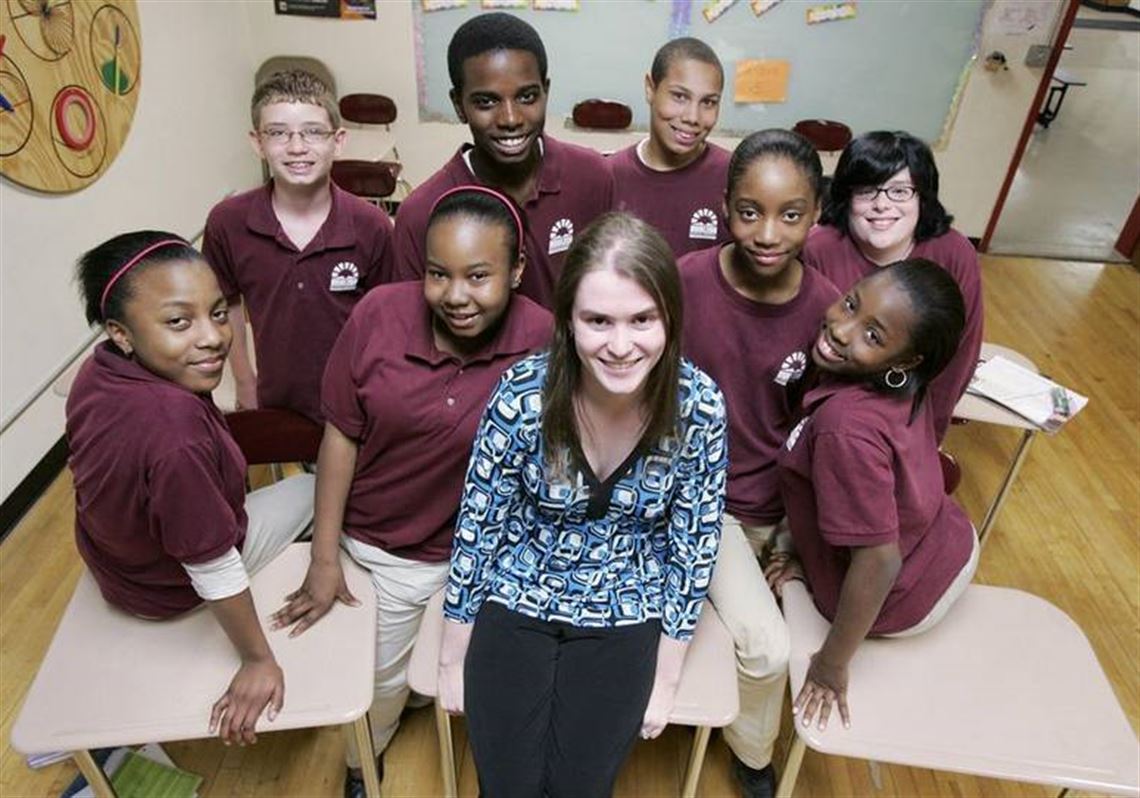 Eight of the 11 team members of the winning Smartys team surround teacher Lauren Hablitzel-Lake. (THE BLADE/DAVE ZAPOTOSKY)<br><img src=http://www.toledoblade.com/assets/gif/TO17150419.GIF> VIEW: <a href=" /assets/pdf/TO44653429.PDF" target="_blank "><b>Final standings, portfolio values</b></a>