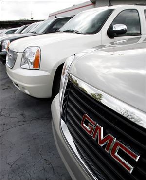 The company has cut production of light trucks such as these sport utility vehicles.