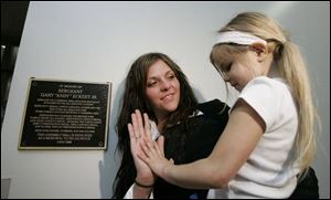 Tiphany Eckert touches her daughter, Marlee, after the unveiling of a plaque for her father, Sgt. Gary 'Andy' Eckert, Jr. (THE BLADE/DAVE ZAPOTOSKY)
<br>
<img src=http://www.toledoblade.com/graphics/icons/photo.gif> <b><font color=red>VIEW</b></font color=red>: <a href=