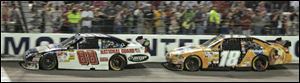 Dale Earnhardt Jr. leads Kyle Busch, moments before an accident that sent Earnhardt into the wall and to a 15th-place finish.