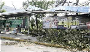 Residents sit at a bus station among debris left by the weekend's devastating cyclone on Tuesday, in Yangon, Myanmar. (ASSOCIATED PRESS)
<br>
<img src=http://www.toledoblade.com/graphics/icons/video.gif> <b><font color=red>AP VIDEO</b></font color=red>: <a href=