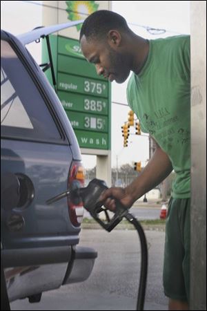Rick Willis pumps $20 worth of gas into his Ford Explorer at
the BP station at Detroit Avenue and I-75.
