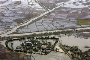 An aerial view of devastation caused by the cyclone Nargis on Saturday, is seen at an unknown location in Myanmar on Tuesday. Myanmar's Irrawaddy delta, where nearly 22,000 people perished, remained largely cut off from the rest of the world Tuesday, four days after a cyclone unleashed winds, floods and high tidal waves on the densely populated region. (ASSOCIATED PRESS)
<br>
<img src=http://www.toledoblade.com/graphics/icons/video.gif> VIDEO: <a href=