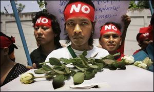 Demonstrators carry a mock ballot box during an anti Myanmar government rally.