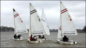 A team of three boats from Ohio State University competes in the Owens Team Race Invitational. Eight teams attended the event, held yesterday on the Ottawa River near the Jolly Roger Sailing Club. Inclement weather forced the event to drop the number of heats from 28 to 18.  

