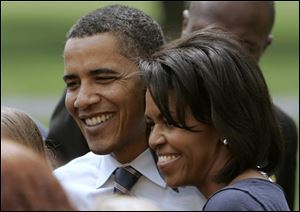 Democratic presidential hopeful, Sen. Barack Obama, D-Ill., left, and his wife Michelle Obama pose for photos with working families after a discussion at Montgomery County Community College in Blue Bell, Pa., Monday, April 21, 2008.