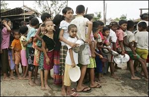 Myanmar children line up to receive free rice after the destructive Cyclone Nargis on the outskirts of Yangon, Myanmar, Monday. (ASSOCIATED PRESS)
<br>
<img src=http://www.toledoblade.com/graphics/icons/photo.gif> <b><font color=red>VIEW</b></font color=red>: <a href=