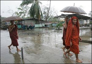 Myanmar Buddhist monks walk in the rain on the outskirts of Yangon, Myanmar on Thursday. (ASSOCIATED PRESS)
<br>
<img src=http://www.toledoblade.com/graphics/icons/photo.gif> <b><font color=red>VIEW</b></font color=red>: <a href=