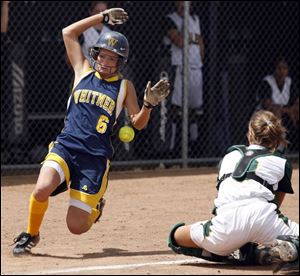Whitmer's Brooke Zaleski scores as the ball gets by Clay
catcher Jessica Achter in the ninth inning. 