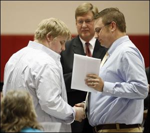 William Payne, Carrie's brother, accepts her diploma from teacher John Kramer the day after she was killed in a crash.