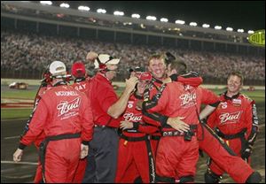 Crew members celebrate driver Kasey Kahne's win in the NASCAR Sprint Cup Coca-Cola 600 auto race at Lowe's Motor Speedway in Concord, N.C. on Sunday.