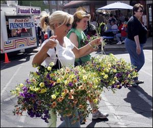 Megan O'Connor and Milissa Fordcharter, both of Toledo, seem happy with their choices during Toledo's annual Flower Day weekend. The event continues from 8 a.m. to noon today. 