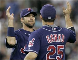 Casey Blake and Ryan Garko high fi ve after the Indians defeated
the Tigers in the opener of their three-game series.