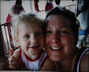 Four-year-old Emily Gerwin of Gibsonburg was fascinated
with airplanes but had never flown until yesterday, when she
took to the air accompanied by her mother, Danielle Gerwin.
