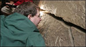 Visitors such as Tom Jackson are allowed to get up close to the walls and rocks of the cave,
formed when seams of gypsum dissolved and allowed surrounding limestone to collapse. (THE BLADE/LORI KING)
<br>
<img src=http://www.toledoblade.com/graphics/icons/photo.gif> <font color=red><b>VIEW</font color=red></b>: <a href=