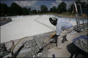 Victor Covington prepares the Detwiler pool. A city spokesman says it will open in June. (THE BLADE/HERRAL LONG)
<br>
<img src=http://www.toledoblade.com/assets/gif/weblink_icon.gif> <font color=red> <b>CITY OF TOLEDO</font color=red></b>: <a href=