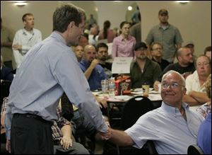 Jon Stainbrook, left, and former Chairman Bob Reichert exchange greetings after Mr. Stainbrook s victory.