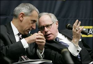 Eric Fingerhut, left, and James Tuschman confer during the UT forum that focused on a greater concentration on STEMM disciplines - science, technology, engineering, math, and medicine.