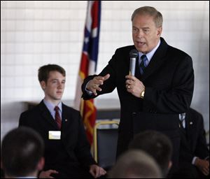 Gov. Ted Strickland speaks to Buckeye Boys State participants at Bowling Green State University yesterday; Nicholas Messenger, newly elected governor of Boys State, looks on.