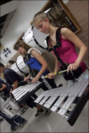 Shannon Novin, left, and Danyna Ferguson play the bells.