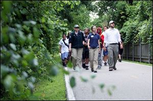 Naturalists Tammy Snowberger, left, Jennifer Berk, and intern David Yafonaro, lead a group of 12-year-olds down the University Parks Trail to Wildwood Preserve Metropark. The walk was part of the National Youth Sports Program. 