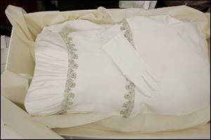 White gloves are left on a preserved and boxed wedding dress at Hallak Cleaners Friday, May 30, 2008, in Hackensack, N.J. The gloves are left in case the owner might want to handle the dress. 
<br>
<img src=http://www.toledoblade.com/graphics/icons/video.gif> <b><font color=red>VIDEO</b></font color=red>: <a href=