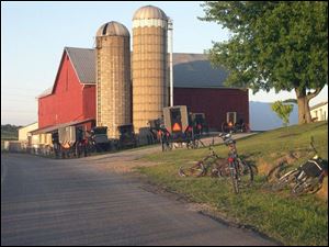Buggies and bicycles are parked outside of Sunday evening church services.
