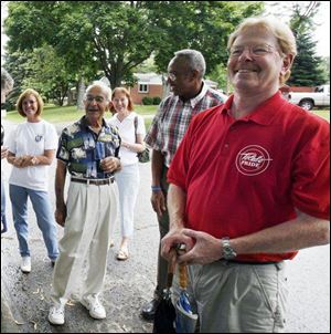 Members stand near - and by - their captain, Michael Dearth, right, who heads the Toledo Block Watch program.