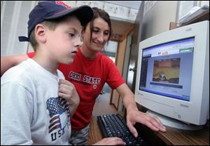 Leslie Boyle watches her son Joey, 6, play games in their Swanton home. She said the therapist broke 'into Joey's shell.'