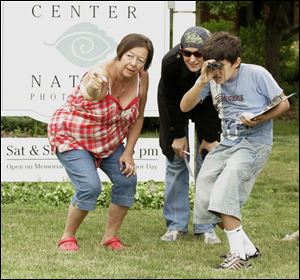 NBRW compass03p  06/25/2008  Blade Photo/Lori King  Olander Park's Sandy Gratop teaches families how to use a compass during the compass course challenge at Secor Metropark in Sylvania,  Ohio, including Elisabeth Elnegres and her son, Abdul Elnegres, 10, of Sylvania.