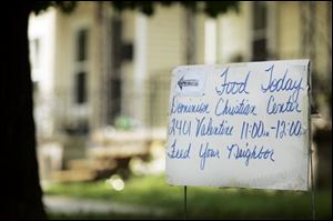A sign points to Dominion Christian Center, where food stamp information was available.
