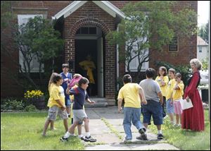 Teacher Deb Rowland supervises a game of tag at Historic Brandville School. 