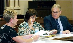 School board members Lisa Sobecki, left, and Darlene Fisher discuss options for Scott High School with Ron Victor, business manager for the city s schools.  I walk away from here thinking that we have more options,  Ms. Sobecki said.

