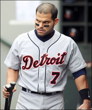 Detroit catcher Ivan Rodriguez leaves the dugout with his equipment after being ejected by home umpire Brian Knight for arguing in the ninth inning after striking out.