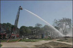 A ladder truck is used to hose down hot spots remaining from the Hunters Ridge fire.