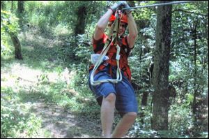 A visitor sails through the treetops
on the zipline.