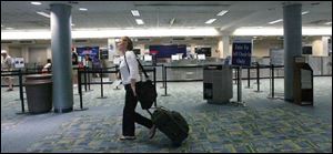 Leslie Getzinger walks past Delta s area as she rushes to catch a flight. By fall, only three airline carriers will be at Express.
