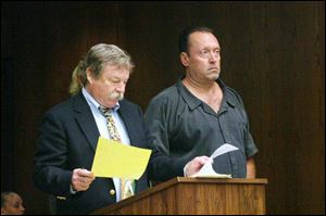 Thomas Bragg, 46, right, accused of felonious assault and attempt to commit an offense, appears with his public defender, James MacHarg, in Toledo Municipal Court yesterday.