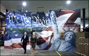 John McCain and his wife, Cindy, arrive at the Bayloff Stamped Products facility in Belleville, Mich., for a town hall meeting.

