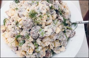 A homemade potato salad with sausage.
