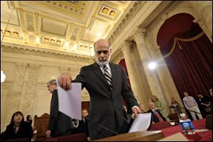 Federal Reserve Board Chairman Ben Bernanke arrives on Capitol Hill in Washington on Tuesday, to report on the economy before the Senate Banking Committee. 