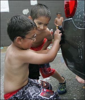 NBRS carwash17p   Kaleb (cq) Serrato, 5, left, of Waterville, and Trey (cq) Chasteen, 6, of Toledo, work on a spot on the back of a Chevy. The Owens Community College child care center holds a fundraising car wash at the college on July 8, 2008. The children will be going on a field trip to Monsoon Lagoon with the money.  The Blade/Jetta Fraser