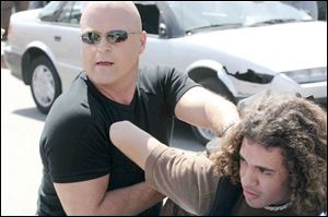 Michael Chiklis, left, who plays Vic Mackey on The Shield, says the writers have put some twists and turns into the final season, but it makes perfect sense.
