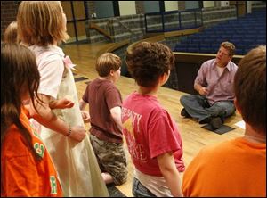 Cast members listen to director Tim Lake at the Perrysburg High School auditorium, where they will perform next week. 