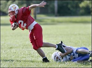 Eastwood's Chad Fairbanks slips a tackle attempt by Springfield's Kellen Taylor earlier this week in an all-star practice.